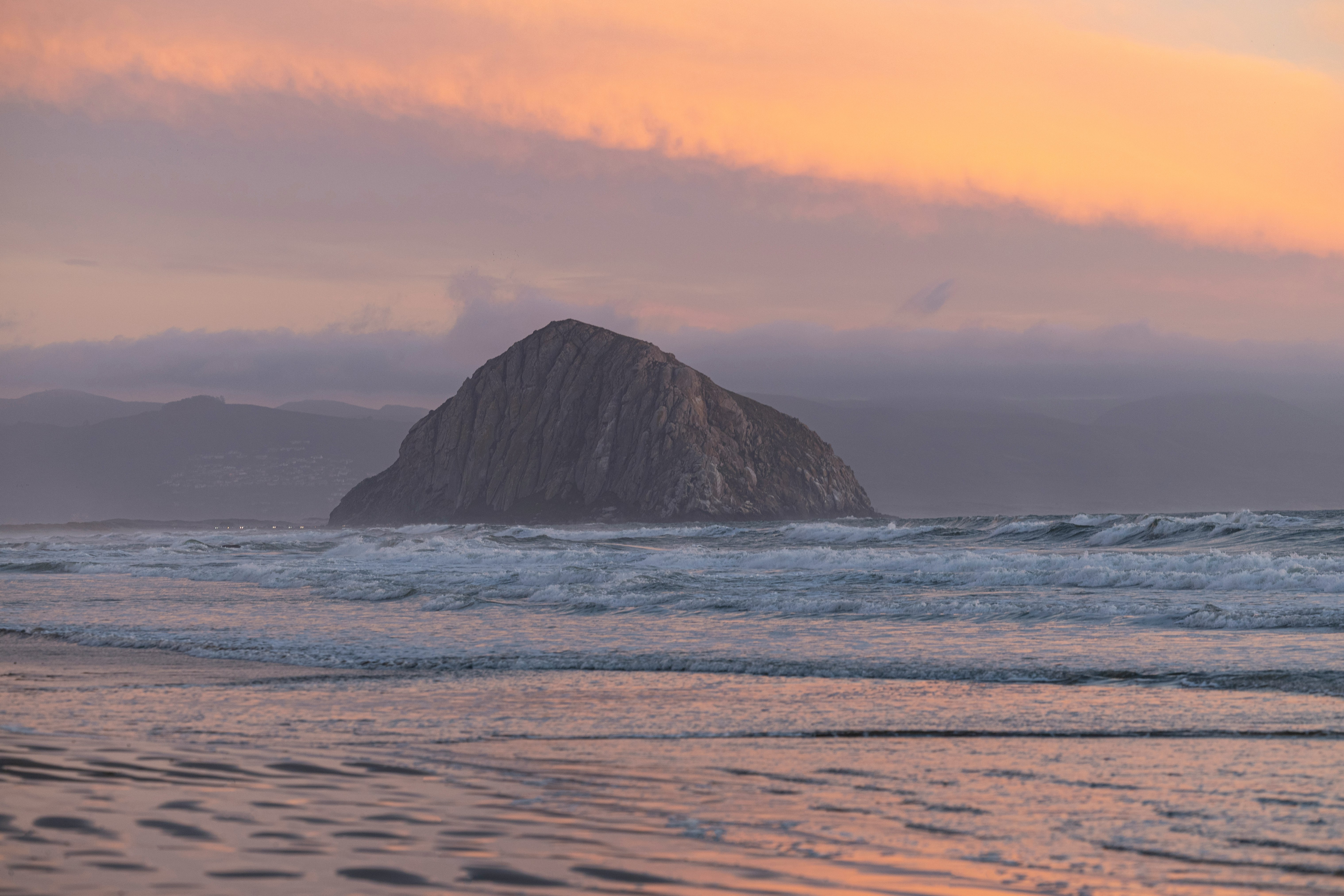 black rock formation on sea during daytime